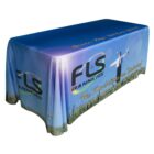 A table covered with a blue and colorful fabric, featuring a logo with the text FLS Banners and the slogan The Possibilities are Unlimited. A silhouette of a person standing in a field is also visible on the fabric.