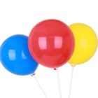 Three balloons are floating against a white background. The balloons are shiny and come in three colors: blue on the left, red in the center, and yellow on the right. They are tied with strings.