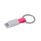 A white USB adapter with a pink silicone loop attached to a silver keyring. The adapter has a Lightning connector on one end.
