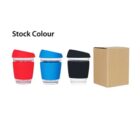 Three reusable cups with red, blue, and black silicone sleeves and lids are lined up next to a cardboard box. The text Stock Colour is above the cups.