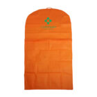 Orange garment bag with a small handle on top, featuring a teal logo and the word COMPANY printed on the upper part. The bag is laid flat against a white background.
