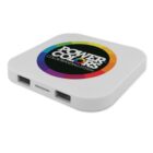 A white square wireless charger with rounded edges. It features a colorful circular logo with the words Power Colors Color Branding System in the center. There are two USB ports on the side.