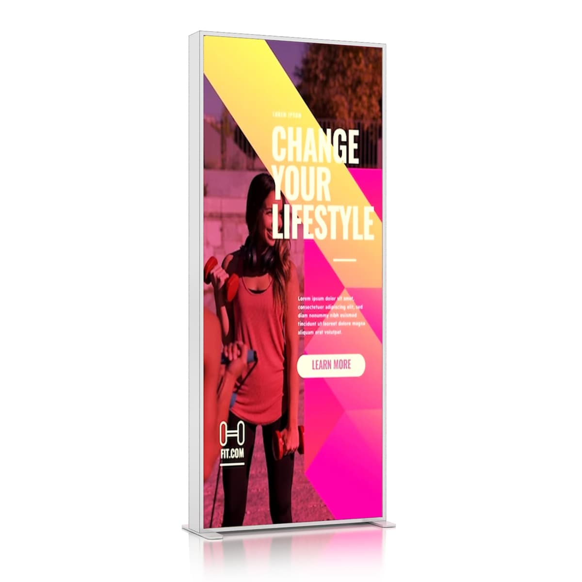 A digital advertising sign displays a fitness-themed poster. It features a woman holding a dumbbell, with overlapping pink and yellow geometric shapes. The text reads Change Your Lifestyle and has a Learn More button at the bottom.