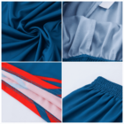 Collage of four images showing details of blue and red athletic shorts. Includes close-ups of gathered blue fabric, blue and white elastic waistband, red side stripes with mesh insert, and overall texture of the materials.