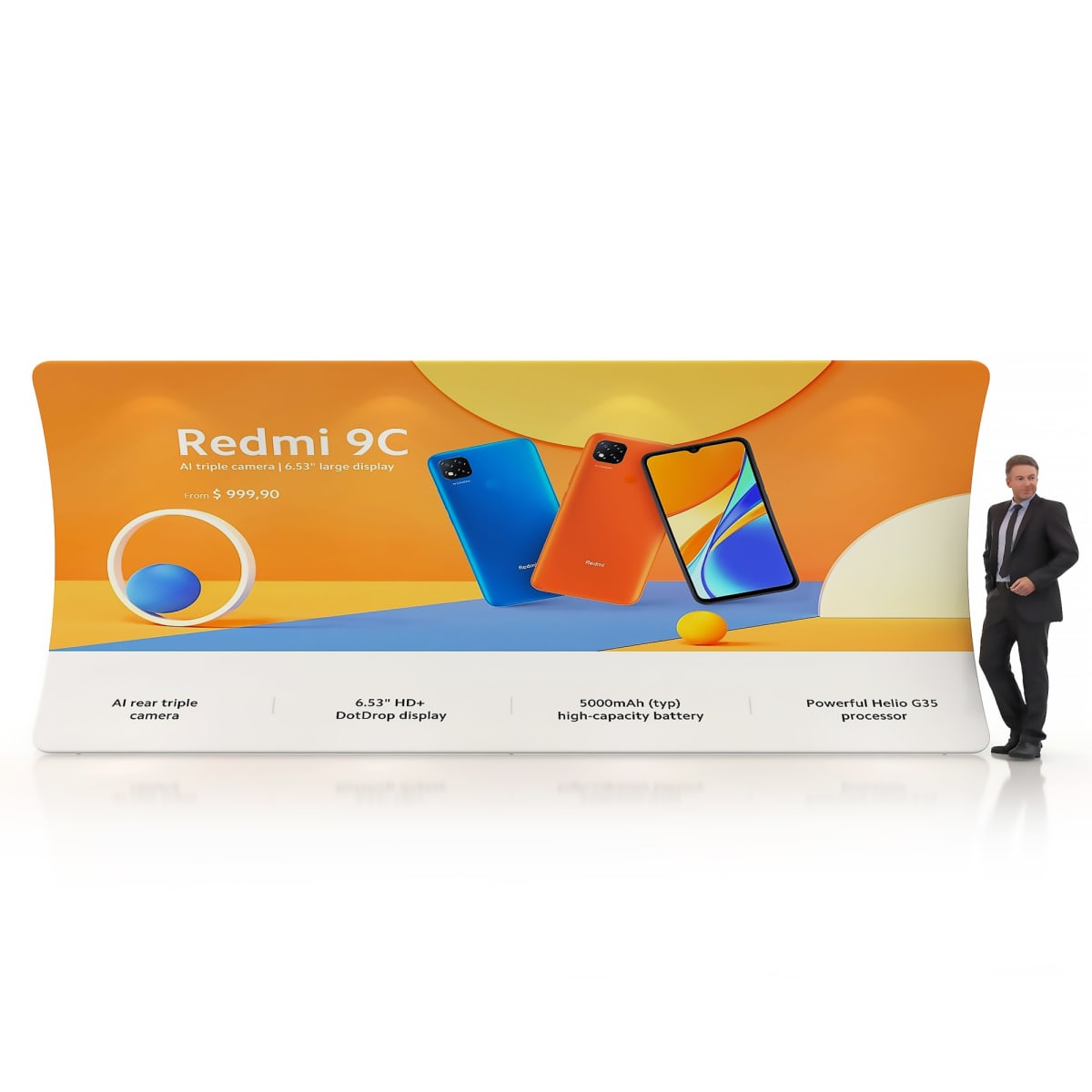 A man in a suit stands beside a large display showcasing the Redmi 9C smartphone. The display highlights features: AI rear triple camera, 6.53 HD+ DotDrop display, 5000mAh battery, and Helio G35 processor.