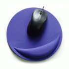 A purple, round ergonomic mouse pad with a wrist rest. A black computer mouse sits on the pad.