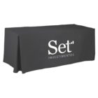 A black table covered with a cloth featuring the white logo and text Set Investimentos. The cloth drapes over the sides and front of the table.