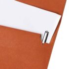 A close-up of an orange folder with a white sheet of paper partially visible inside. A silver pen is clipped to the folder, positioned near the edge. The folder has a textured surface.