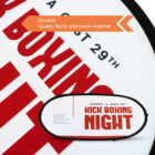 Close-up of a sign with the text Kick Boxing Night, Sunday, August 29th in bold red letters. Above, an orange banner reads Durable, Quality fabric and frame material. The sign has a strong, eye-catching design.