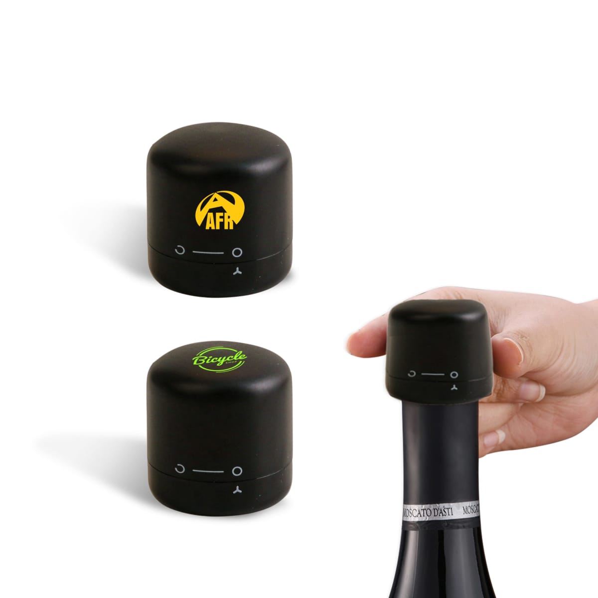 A hand placing a black cylindrical wine bottle stopper onto a bottle. Two similar stoppers are shown above; one has a yellow logo with AFR and the other has a green Boycia logo.
