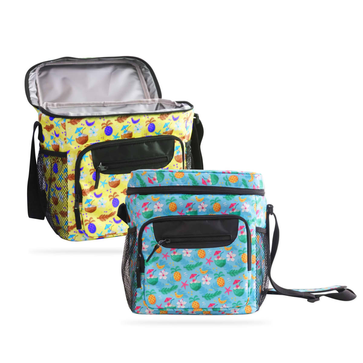 Two insulated lunch bags with colorful patterns. The front bag is light blue with pineapple and fruit designs, and the back bag is yellow with tropical fruit motifs. Both have front pockets and adjustable shoulder straps.