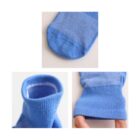 Three cropped images of blue socks: the top shows the toe area, the bottom left displays the opening, highlighting the cuff, and the bottom right shows a hand stretching the sock to demonstrate elasticity and fabric texture.