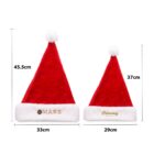 Two red Santa hats with white trim and pom-poms. The left hat is larger and marked MARS, measuring 45.5 cm tall and 33 cm wide. The right hat is smaller, labeled Embroidery Effect, measuring 37 cm tall and 29 cm wide.