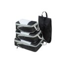 A set of three black and white packing cubes stacked on top of each other and a black shoe bag with a handle, all on a plain white background.