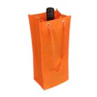 An orange fabric wine bag with two rope handles and metal eyelets at the top, holding a dark bottle upright.