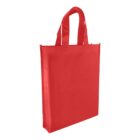 A red, rectangular tote bag with two handles, standing upright. The bag appears to be made of a sturdy fabric, suitable for carrying groceries or books.