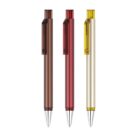 Three ballpoint pens with transparent casings are aligned vertically. From left to right, the pen colors are brown, red, and yellow. Each pen has a clip on the side and silver-colored tips.