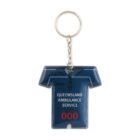 Keychain in the shape of a dark blue shirt featuring the text Queensland Ambulance Service and 000 in red. The shirt has short sleeves with white accents and a collar, attached to a silver chain and ring.