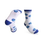 Two white socks with blue cuffs, heels, and toes feature blue floral patterns. One sock is shown flat, while the other is displayed from the side, showcasing the design and color contrast.