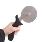 A hand holding a pizza cutter with a round stainless steel blade and a black ergonomic handle against a plain white background.