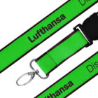Close-up of a green lanyard with the word Lufthansa printed in black. It features a silver lobster clasp and a black plastic buckle.