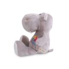 A plush gray hippopotamus toy sits upright, featuring a colorful embroidered logo on its side. The toy has soft, rounded features and white accents on its feet and ears, with a content expression.