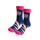 Pair of navy blue socks with pink tops, toes, and heels. Each sock features a pink geometric flower pattern near the top and pink diagonal stripes around the foot and ankle.