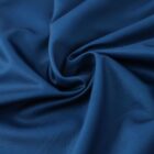 Close-up of dark blue fabric, gathered into a spiral formation at the center. The material has a smooth, slightly shiny surface with subtle folds and creases that create a textured appearance.
