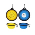 Collapsible pet bowls in yellow and blue, each with a black rim and attached carabiner. The yellow bowl displays Vision Australia with a fish logo, while the blue bowl shows Volunteer and a heart logo for Ronald McDonald House Charities Greater Western Sydney.