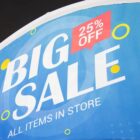 Blue sale banner with white and yellow text: BIG SALE on the left, with 25% OFF in a red circular badge on the top right corner. Smaller text below reads: ALL ITEMS IN STORE. Bright, scattered yellow circles add decoration.