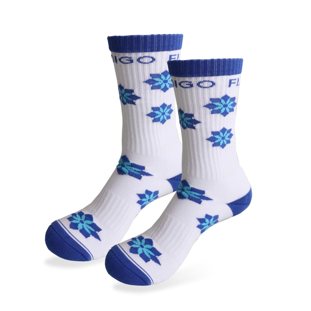 A pair of white crew socks featuring blue and teal snowflake patterns. The socks have blue toe and heel sections, and a blue top band with the word FLIGO printed repeatedly around the cuff.