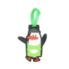 Rubber luggage tag featuring a cartoon penguin with a green hat and outfit. The penguin has orange beak and feet and is attached to a green strap.