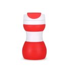 A red and white sippy cup with a curvy design and a closed spout cap. The cup is standing upright on a plain white background.