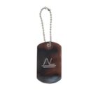 A metal dog tag with a ball chain, featuring a logo of intertwined letters N and V above two horizontal lines. The tag has a shiny, reflective surface.