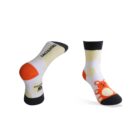 Two white socks with black cuffs, heels, and toes. One sock displays a red bear design, while the other features a red panda face. Both have yellow shapes throughout.