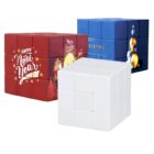 Three cubes with designs: a red cube with Happy New Year and holiday graphics, a blue cube with Merry Christmas and ornaments, and a plain white cube in front.