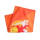An orange towel featuring a basketball player silhouette and a flaming basketball design in white, yellow, and red colors. The towel is neatly folded.