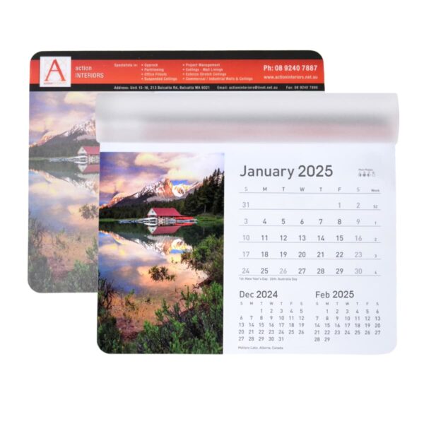 Wall calendar open to January 2025 showing a scenic lake and mountain view with a cabin. Below are calendars for December 2024 and February 2025. The calendar is branded Action Interiors with contact details on top.