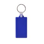 A blue rectangular keychain with a metal ring sits against a white background. The keychain has a small tab connecting it to the ring, and the surface appears smooth and glossy.