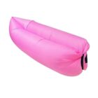 Inflatable pink lounge chair, resembling a hammock, partially inflated and lying on a flat surface, designed for outdoor relaxation or lounging.