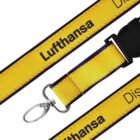 Yellow lanyard with Lufthansa printed in black text. It features a metal clip and a plastic buckle.