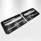 A foldable black plastic case is open, displaying several white rods of varying lengths neatly arranged inside. The case appears to be part of a portable or collapsible structure.