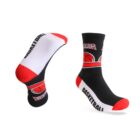 Two black socks with red and white accents are shown. They feature a basketball graphic and the word BASKETBALL in white text on the sole. One sock is upright, while the other is positioned to display the sole.