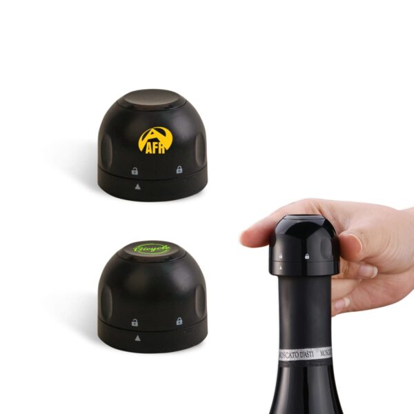 A hand placing a black bottle stopper on a wine bottle. Two similar black stoppers are shown next to it, each featuring a different logo on top. All stoppers have lock symbols on them.