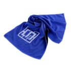 A blue fabric towel is spread out with a modern abstract design in white on its surface. The towel appears to be lightweight with a textured pattern.