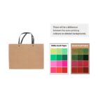 A brown paper bag with black handles is next to a comparison chart showing color differences on white and brown kraft paper. The chart emphasizes variation in printing colors on different backgrounds.