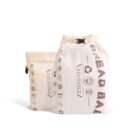 Two beige reusable bags are displayed. The bags have decorative icons and text, with one saying BREAD BAG and the other REUSABLE. Both have drawstring closures and simple graphics illustrating food-related items.