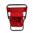 A red folding chair with a metal frame, featuring a fabric seat and backrest. There is a small fabric storage compartment under the seat, designed for portability and convenience.