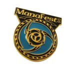 A gold and teal enamel pin with the text ManaFest 95. The design features a circular emblem with swirling patterns and a triangular motif in the center.