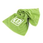 A crumpled green cloth with a textured pattern and a white geometric logo displayed on it, set against a plain white background.